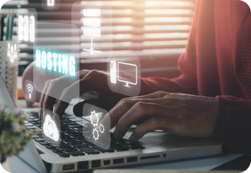 Person typing on a laptop with floating digital icons, including 'HOSTING' in bright blue, symbolizing web hosting, cloud services, and digital connectivity in a cozy work environment.