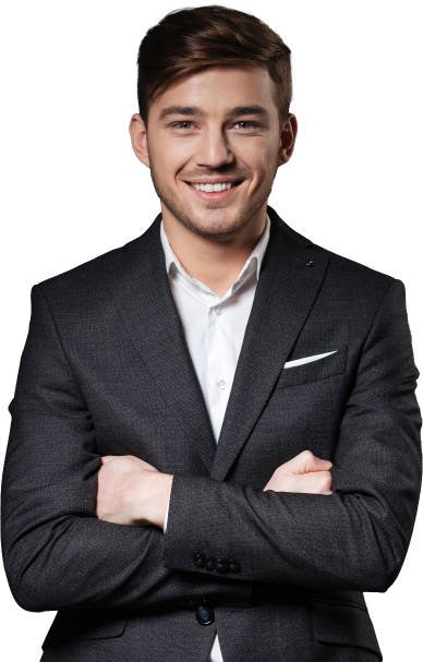 A young man in a dark suit jacket and white shirt, smiling confidently with arms crossed, representing professionalism and approachability in SAP consulting and business services against a plain background